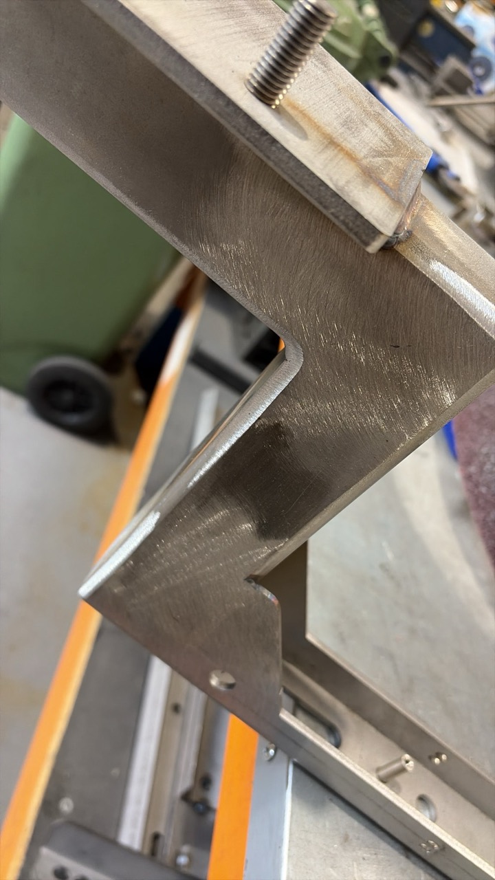Bracket after sanding — clean weld grain blend