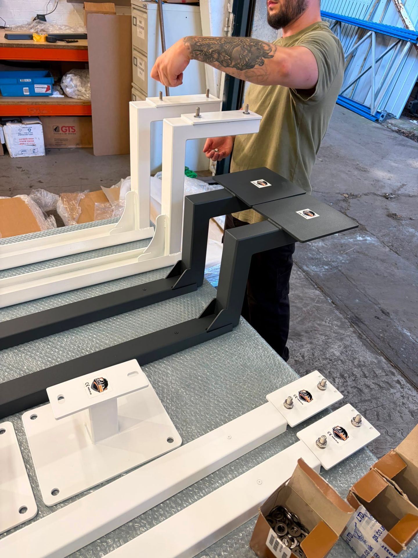 Bespoke stainless awning brackets — matched pairs in white and anthracite
