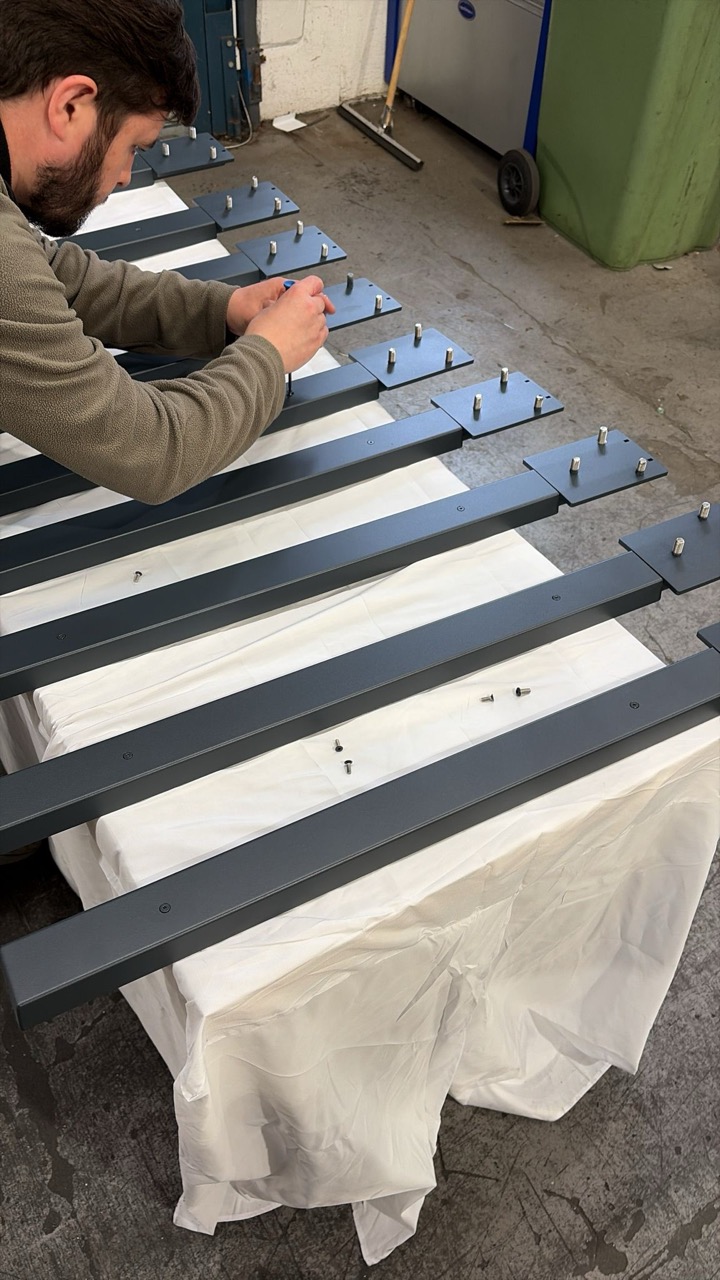 Hand-assembly of stud plates in the workshop
