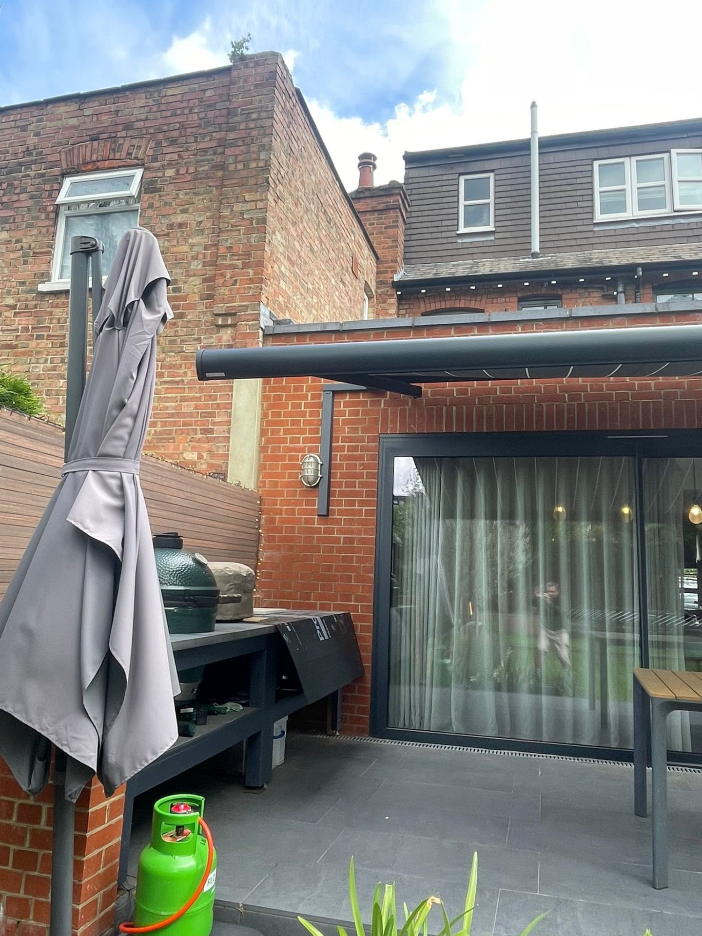 Awning retracted — discreet anthracite cassette and bracket profile