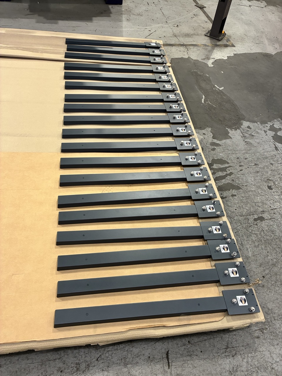Batch of TIG-welded brackets laid out for QC