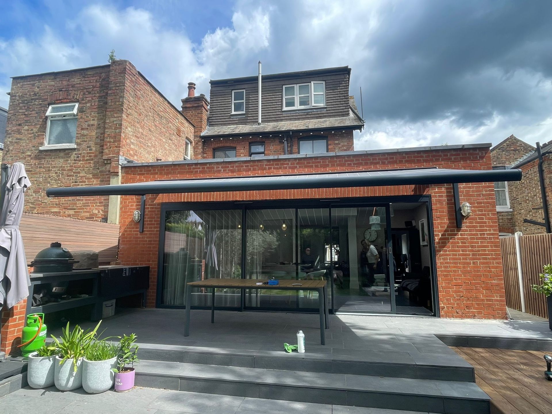 Installed full-width retractable awning on a London rear extension