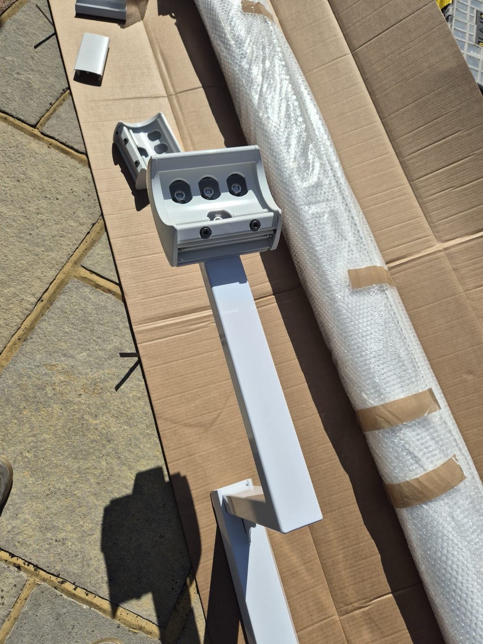 Close-up of wall bolts and fixings securing the awning support post