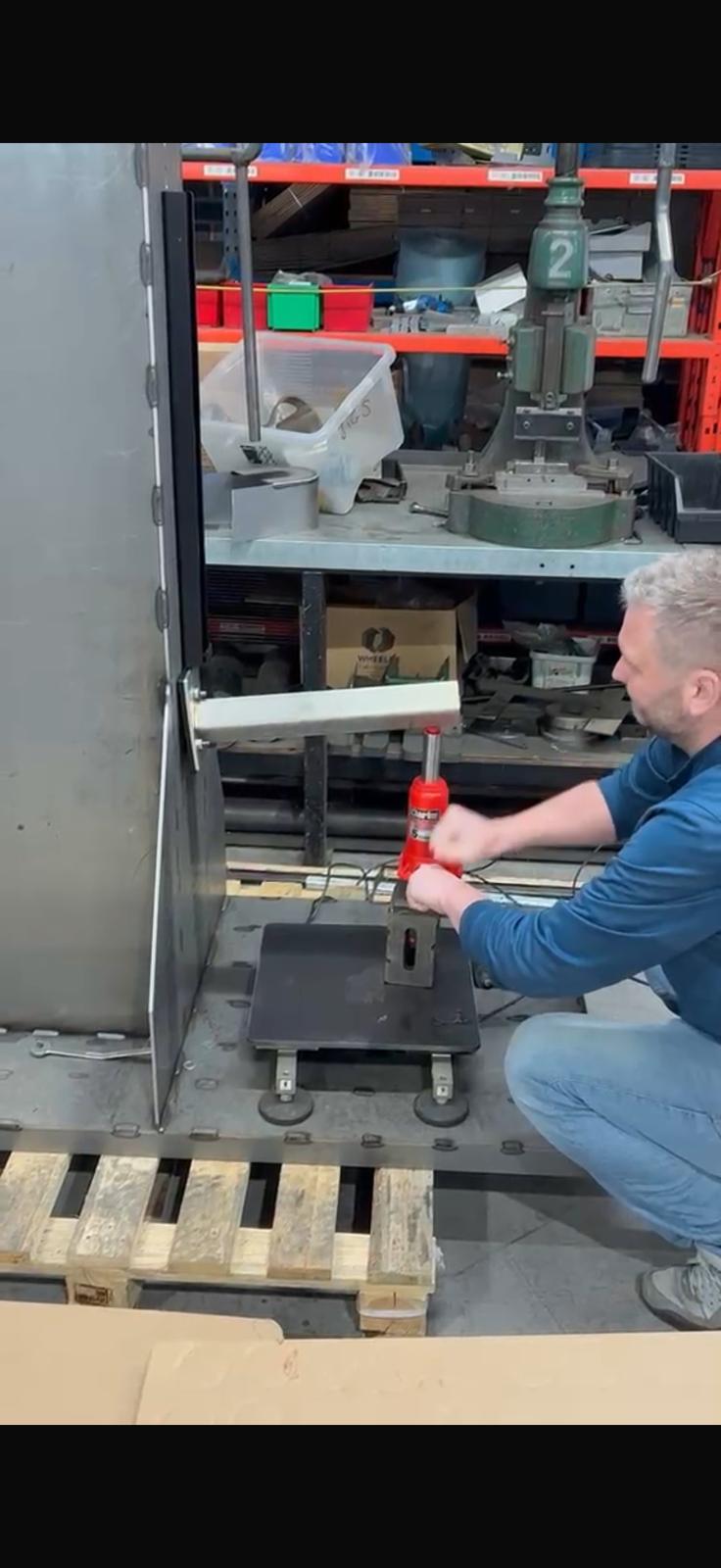 An engineer applying load to a bracket on the LoadBear test rig