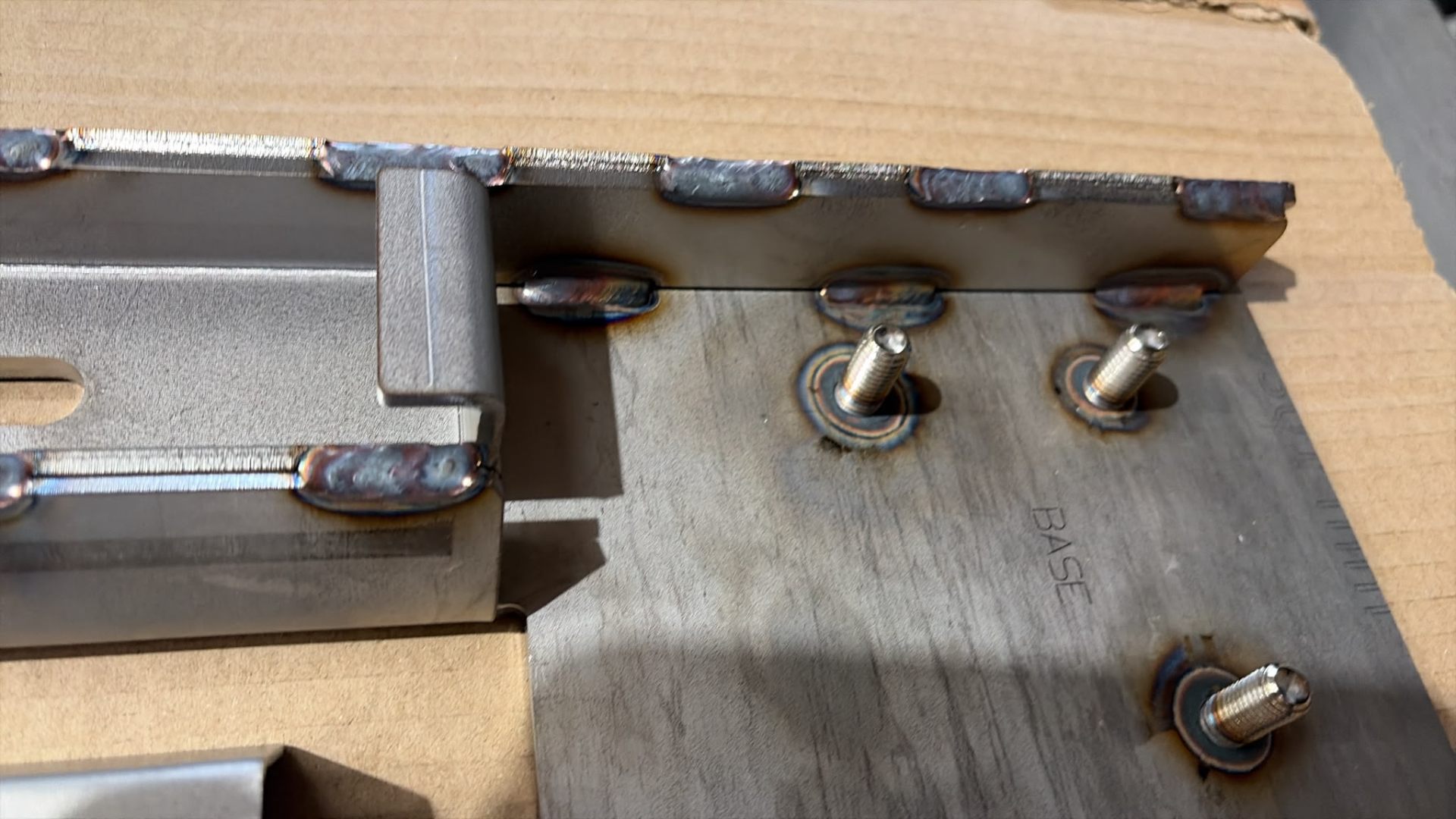Close-up of TIG welds and forged stainless studs on the Heavy-Duty Spreader base plate