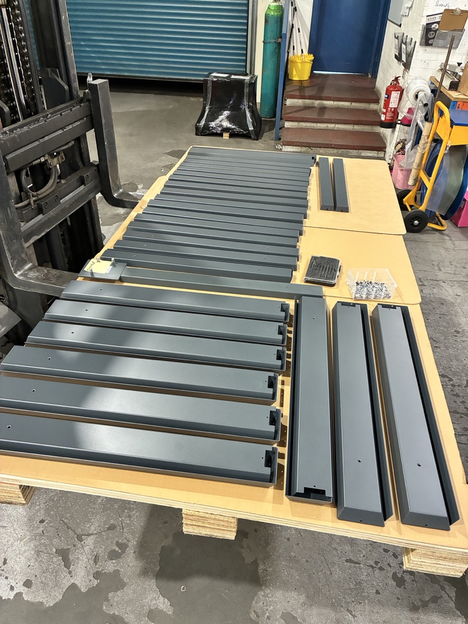 Production run — anthracite spreader brackets ready for despatch